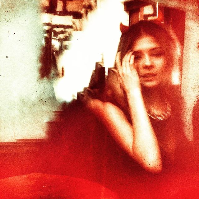 Profile of woman's face stylized and edited with hellish coloring.