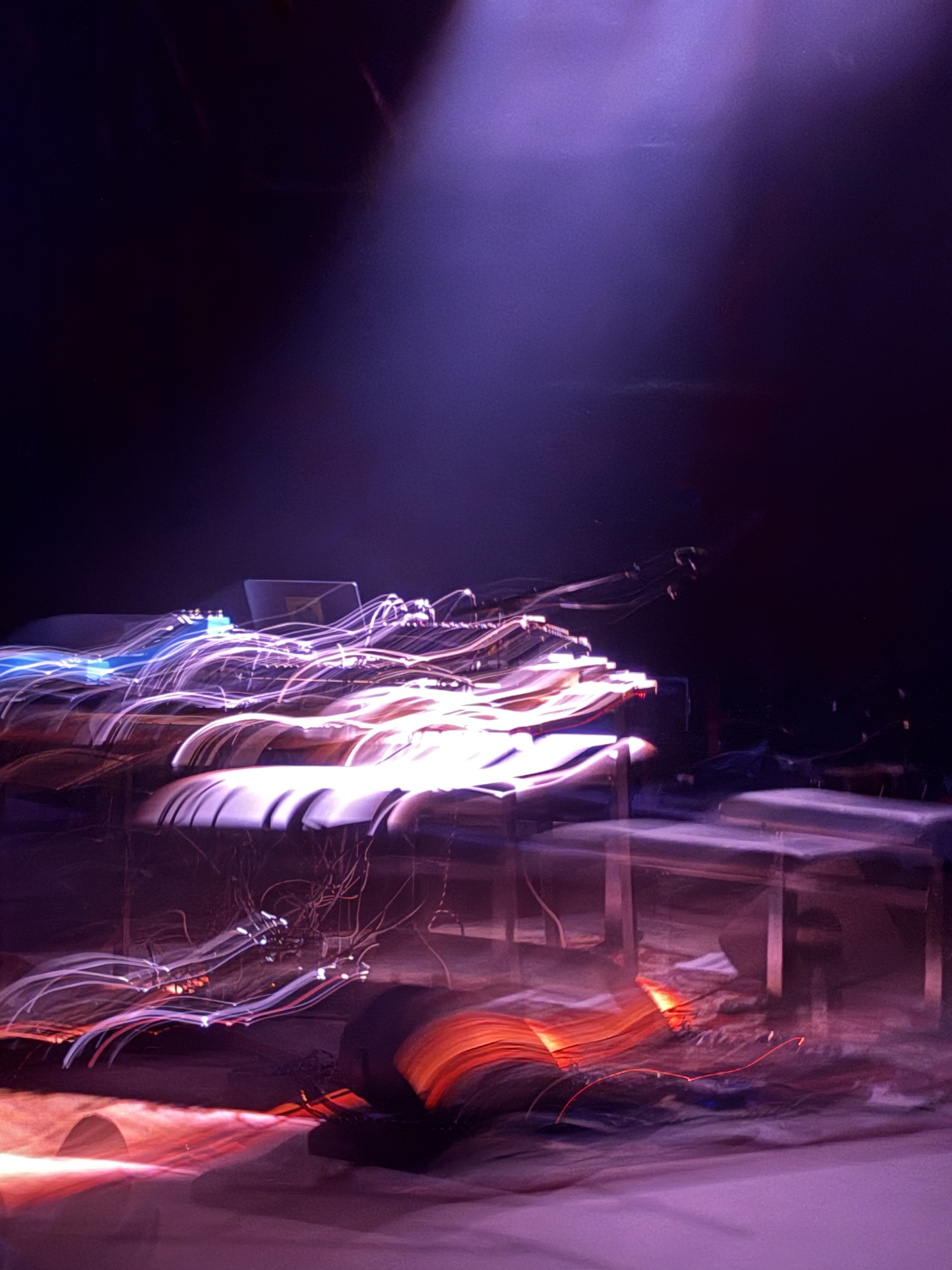 A streaked image of electronic music gear on stage.